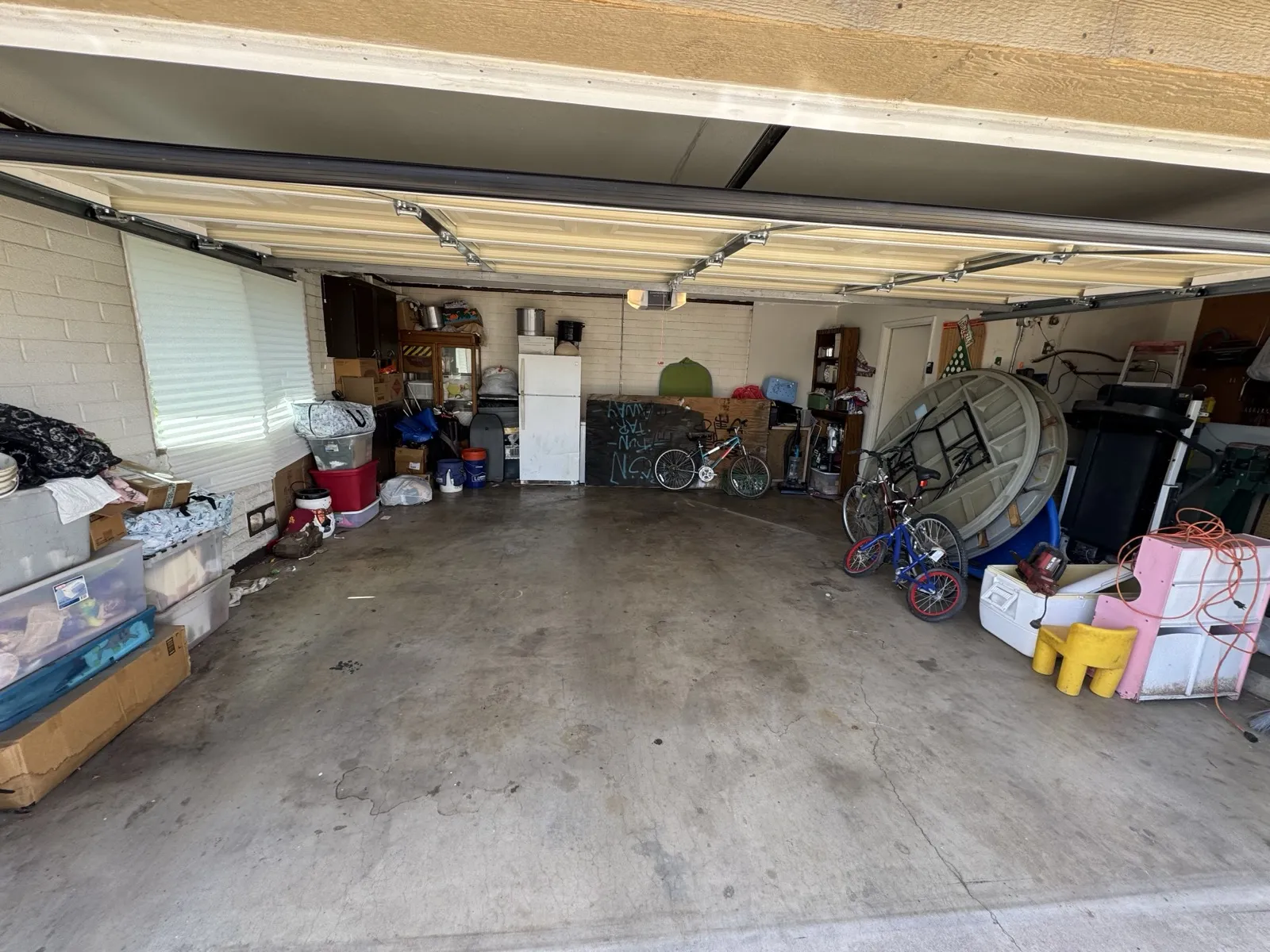 Before photo of a cluttered garage ready for cleanout